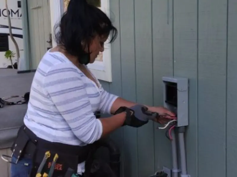 Licensed electrician wiring an exterior subpanel in Pine City